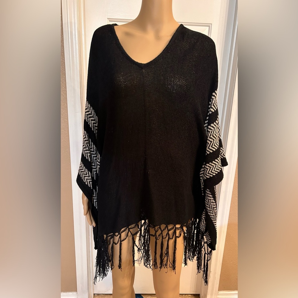 Shaw like knitted dress with fringe